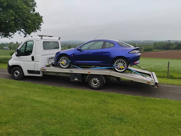Blue Ford Puma Racing strapped down on Ian's transporter in Abergavenny, ready for delivery to Southampton docks