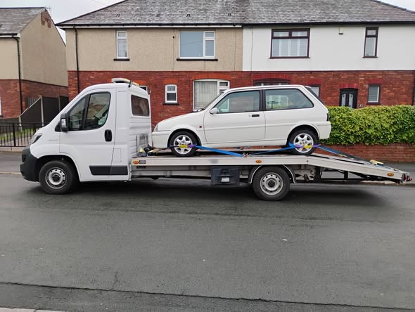 White Rover Metro GTa loaded and secured on Ian's transporter in Leigh, near Manchester, ready for delivery to Hereford