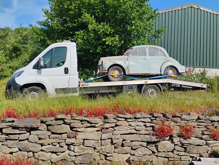 Pale blue Morris Minor secured on Ian's transporter near Clyro, on its way to Llanwarne as a parts donor car