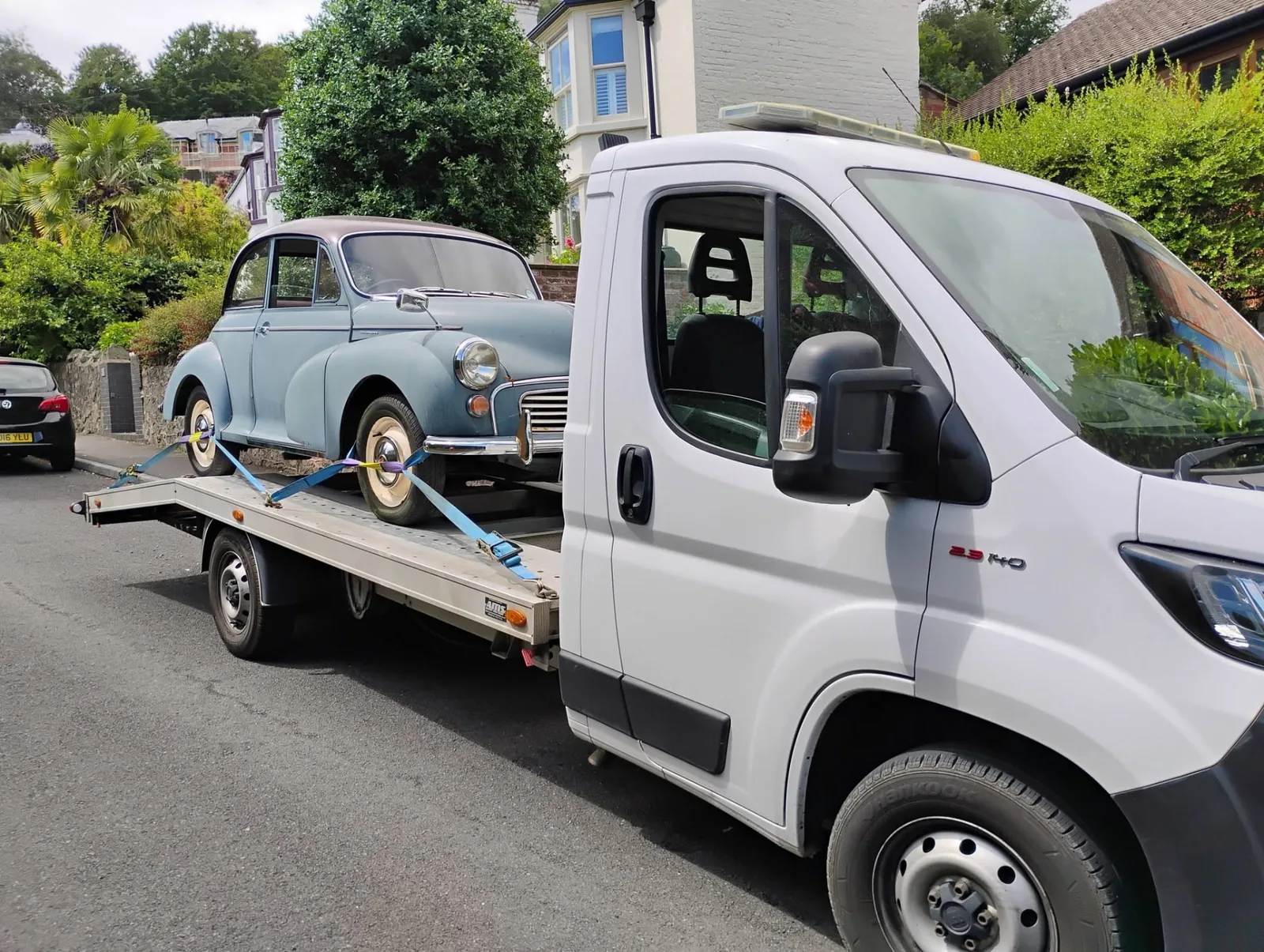 Classic Morris Minor strapped onto the transporter