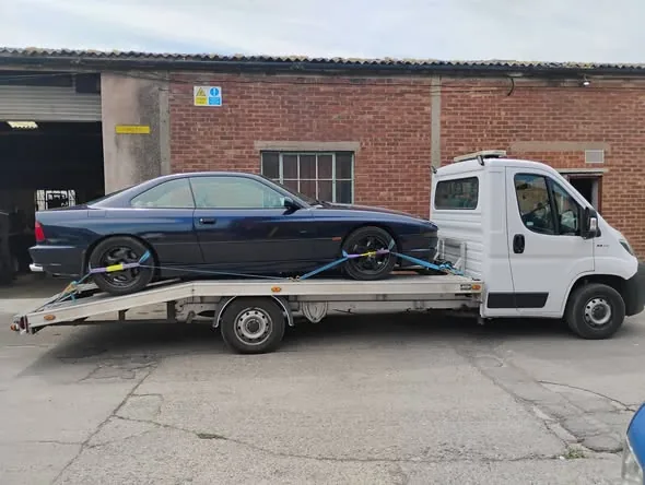 Dark blue BMW 8 Series coupe loaded for delivery