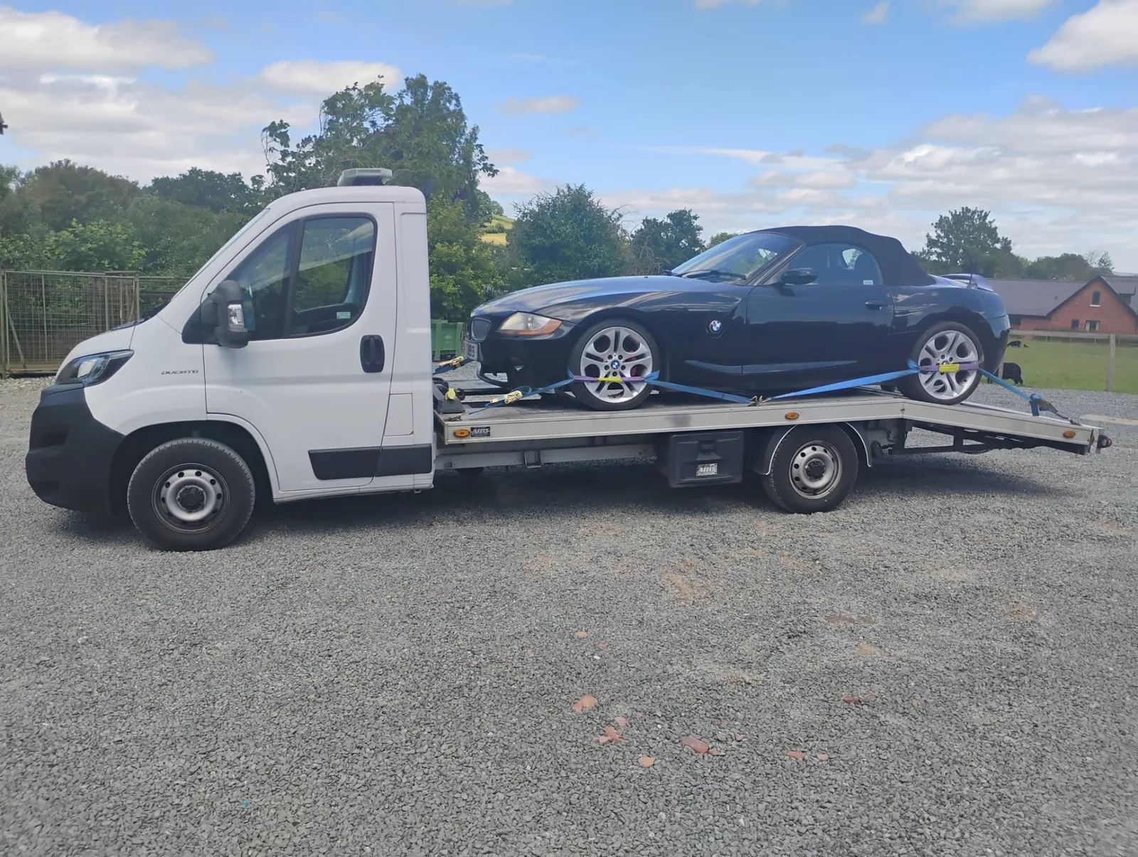Dark blue BMW Z4 roadster loaded for delivery to storage in Hereford